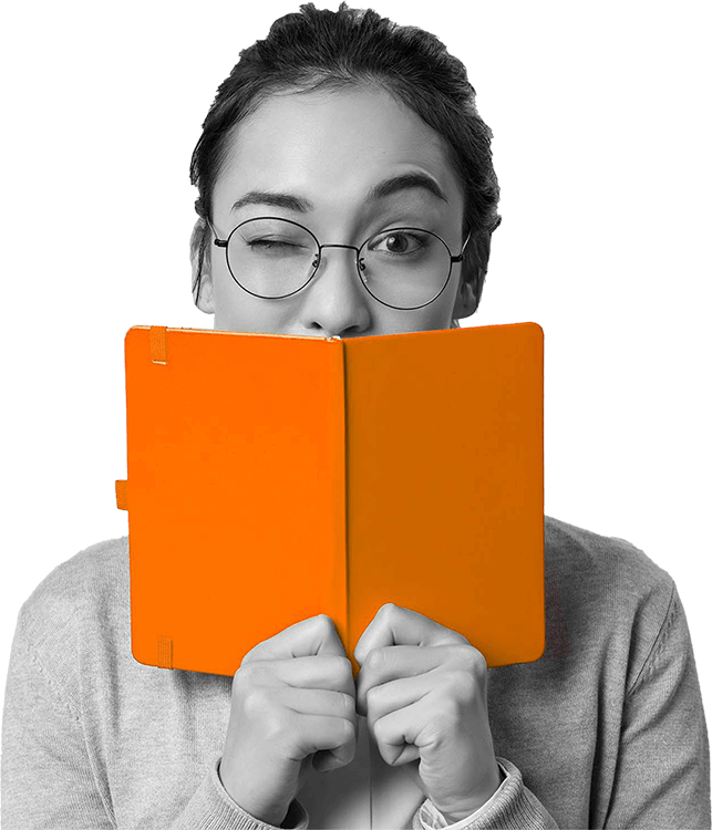 A creative strategist winking playfully over a bright red book, symbolizing our agency's unique brand strategies.